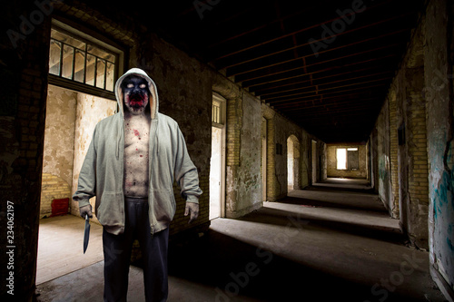 Evil Demon Zombie Ghost Monster With Knife In Delerict Building photo