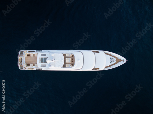 Top-down view of white luxury motor yacht in ocean © VaLife