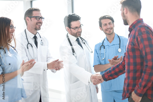 doctors congratulating the patient on recovery photo
