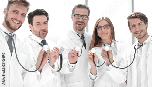 group of doctors hold their stethoscopes