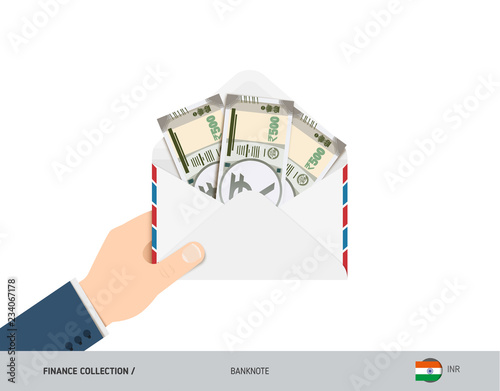 500 Indian Rupee Banknotes in envelope hold in hand. Flat style opened white envelope with cash. Salary payout or corruption concept.