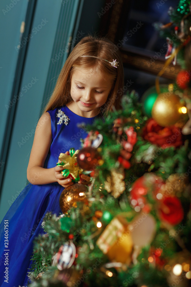 Little blonde girl in blue dress, new year