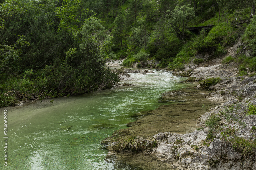 A valley between mountains with a small river A valley between mountains with a small river