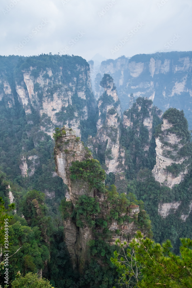 Zhangjiajie Forest Park. Panoramic view above the cliffs and mountains to the colorful valley. Picturesque landscape. Majestic nature. China, January 2017.