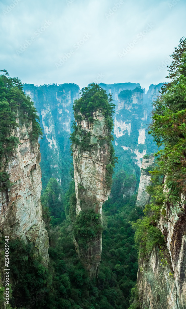 Zhangjiajie Forest Park. Panoramic view above the cliffs and mountains to the colorful valley. Picturesque landscape. Majestic nature. China, January 2017.