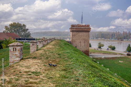 Bild auf Leinwand Landscape view of fortress wall and tower near the river Drava