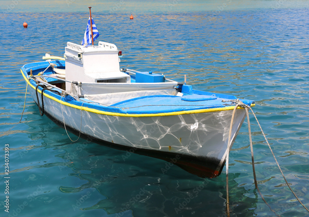 Wooden Fishing Boat with Greek Flag at Kastellorizo Harbor,Greece