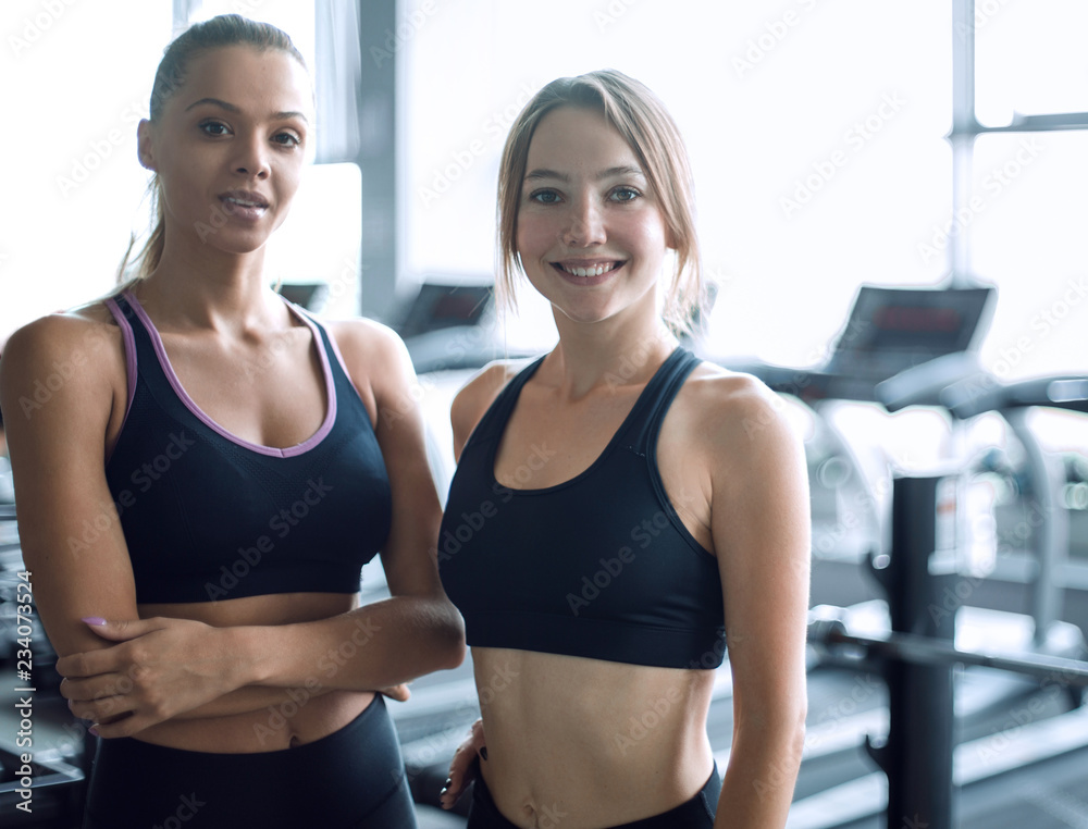 two young woman on the background of the gym