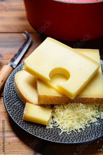 Assortment of Swiss cheeses Emmental or Emmentaler medium-hard cheese with round holes, Gruyere, appenzeller and raclette used for traditional cheese fondue and gratin