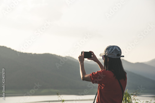 tourism woman hold camera for take a photo mountain and lake in journey trip