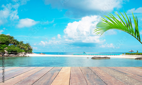 empty wood desk and summer blue sea background and leaf coconut palm tree .Blank space for text and images.Concept Summer, Beach, Sea, Relax, Party.