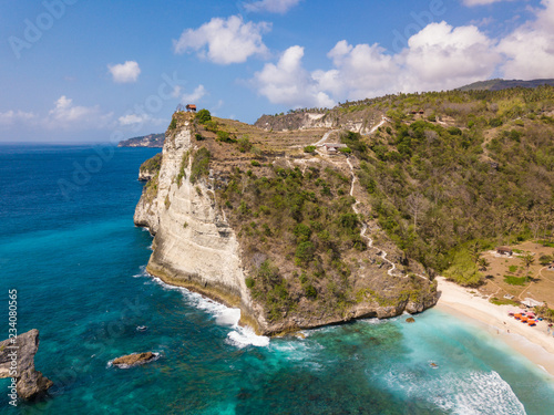 Aerial view to beautiful rock cliff in ocean on Atuh beach. Photo from drone. Nusa Penida, Bali, Indonesia