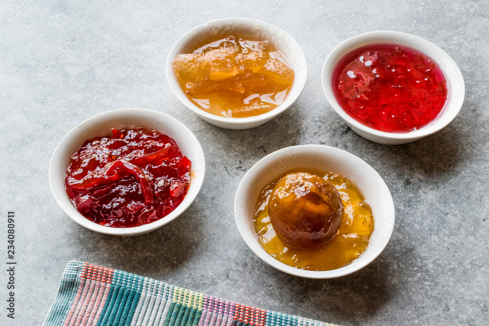 Assorted Variety of Jams and Marmalades; Rose, Red Pepper, Mandarin and Citron Peel in Small Bowl. Assorted Variety of Jams and Marmalades; Rose, Red Pepper, Mandarin and Citron Peel in Small Bowl.
