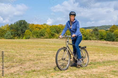 European woman on mountain bike in german nature
