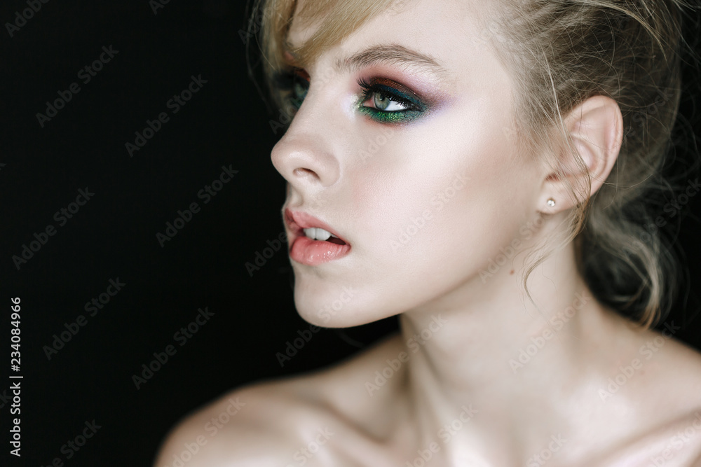 Young Beauty Fashion Model Posing on Black Background, Looking Right Side. Woman with Shiny Perfect skin and Natural Makeup. Head Close-up Portrait. Young Beauty Fashion Model Posing on Black Background, Looking Right Side. Woman with Shiny Perfect skin and Natural Makeup. Head Close-up Portrait.