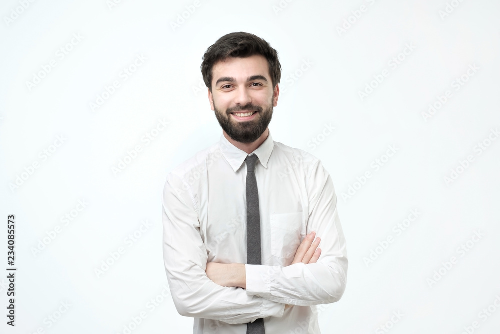 smiling man with crossed arms over gray background smiling man with crossed arms over gray background
