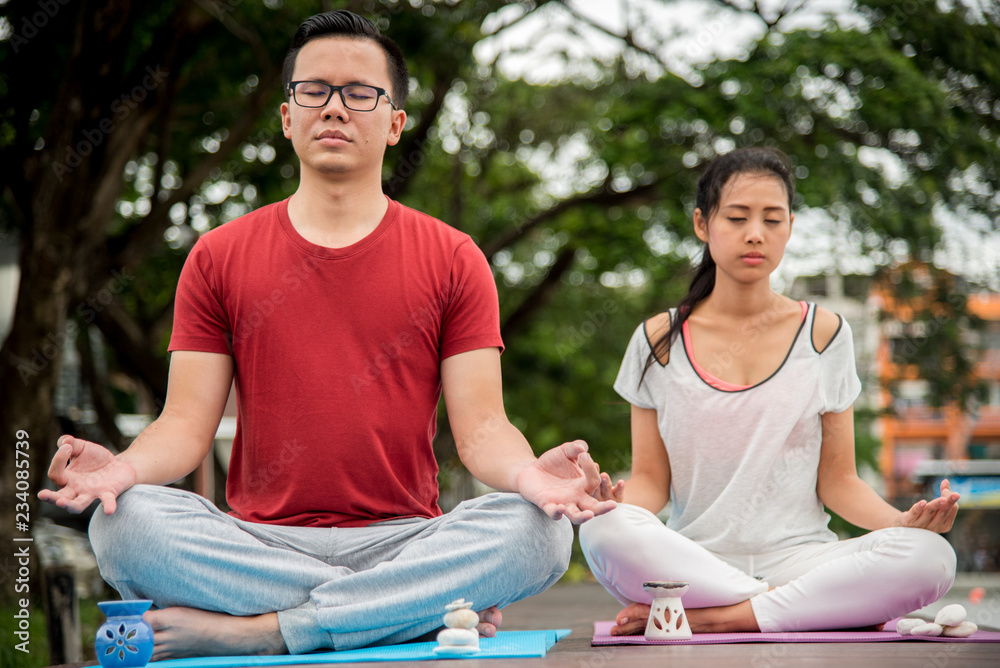 Young couple relaxing in yoga pose