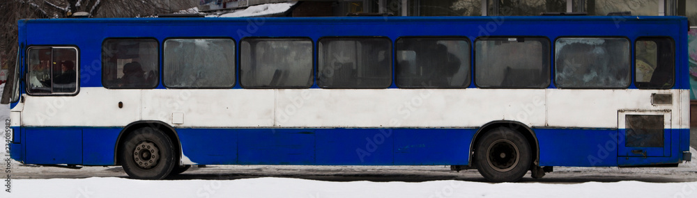 Big city bus side view. Ust-Kamenogorsk (Kazakhstan). Public bus. Old bus. Transport. Long white blue bus. Public transport. Passenger transportation