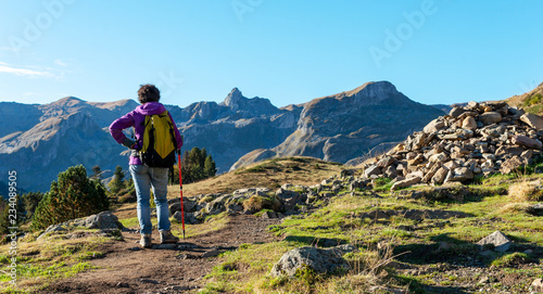 woman hiker walking in the Pyrenees mountains near the Pic Ossau