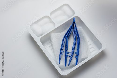 Фотография Disposable sterile dressing set on white table