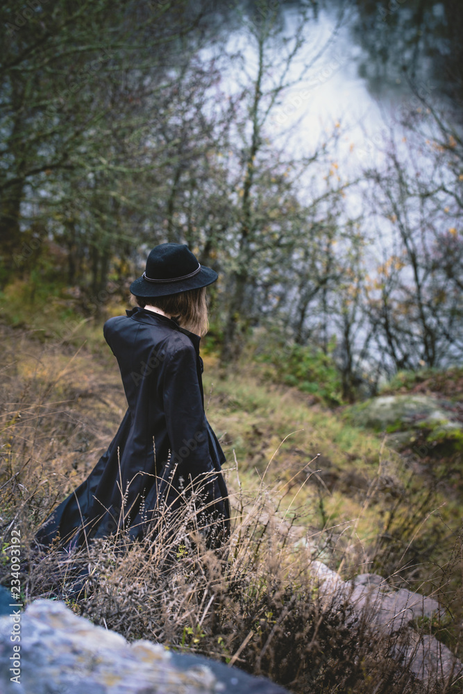 A girl above the river, view from above A girl above the river, view from above