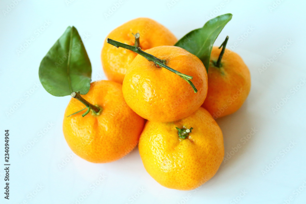 Bright fresh tangerines. Close-up. Isolated object on white background. Isolate. Bright fresh tangerines. Close-up. Isolated object on white background. Isolate.