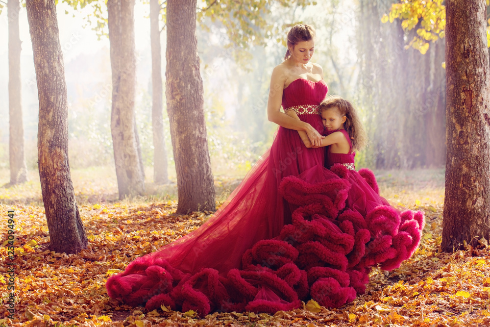 Fototapeta premium Mom and daughter in luxurious dresses