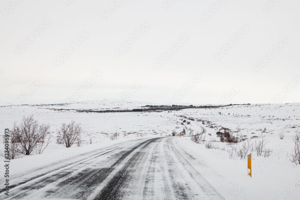 Fototapeta premium Beautiful and dangerous driving road in winter snow Iceland