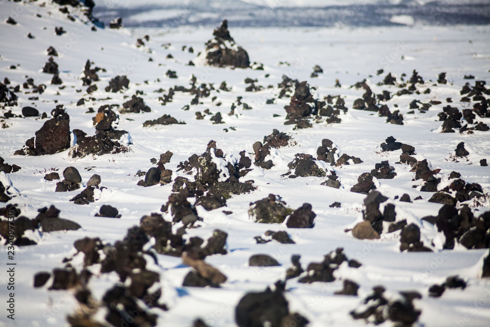 Fototapeta premium Laufskalavarda view during winter which is a lava ridge, surrounded by stone cairns, between the Holmsa and Skalma Rivers