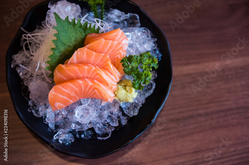 Salmon sashimi on wooden table by top view