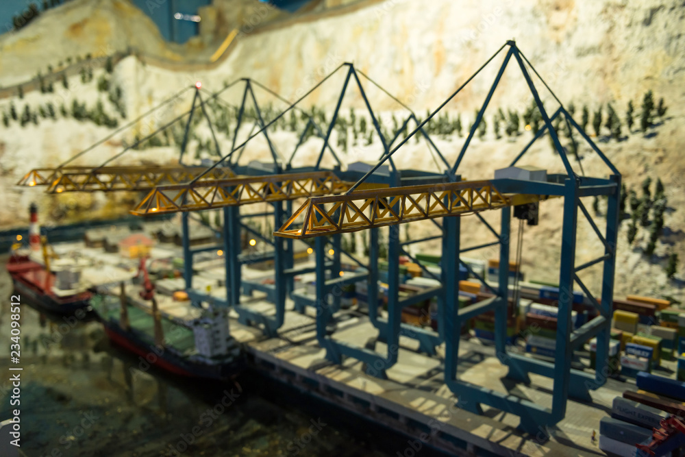 Miniature model of cranes at shipping dock