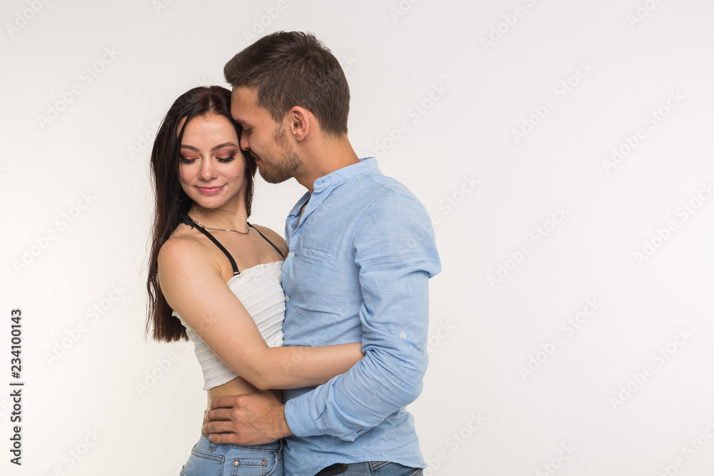 Relationship and family concept - Portrait of hugging couple on white background with copy space Relationship and family concept - Portrait of hugging couple on white background with copy space