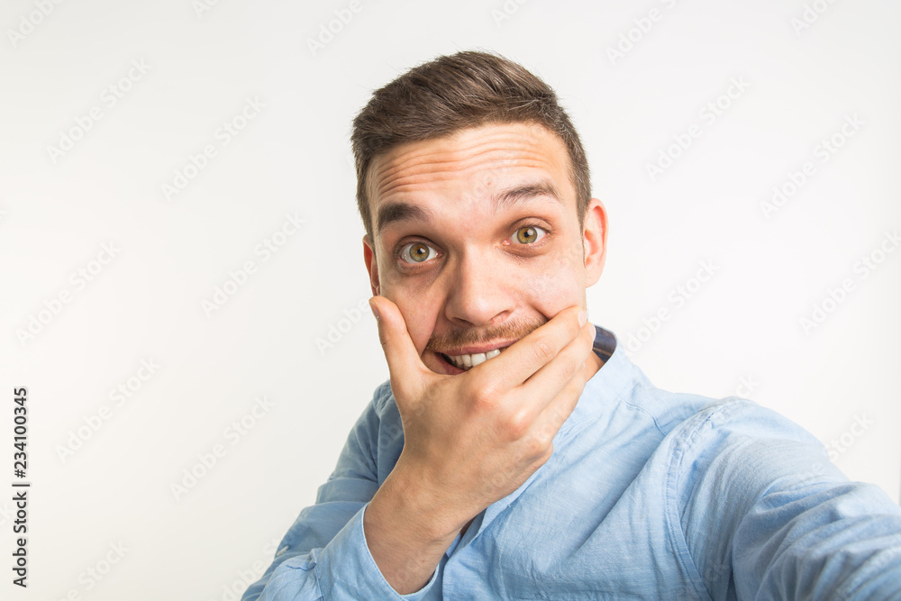 Close up portrait of a cheerful bearded man taking selfie over white background Close up portrait of a cheerful bearded man taking selfie over white background