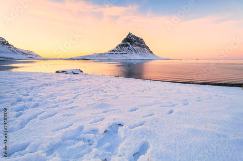 Kirkjufell view during winter snow which is a high mountain on the north coast of Iceland's Snaefellsnes peninsula, near the town of Grundarfjordur 