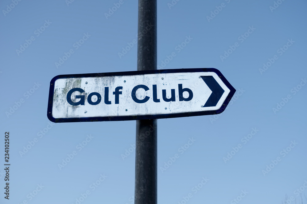 Golf club sign directional against empty blank blue sky Golf club sign directional against empty blank blue sky