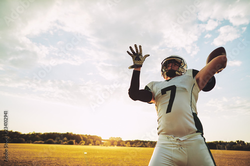 Football quarterback about to throw a pass during team practice photo