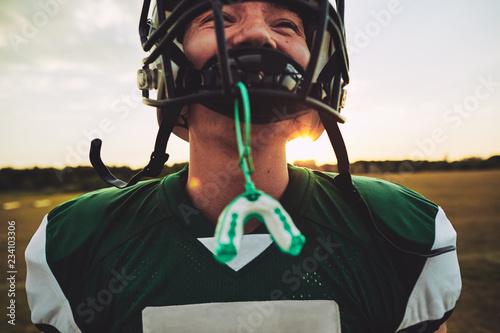 Young American football player standing on a field during practi photo