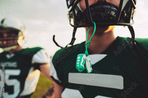 Young American football player with his mouthguard out during pr