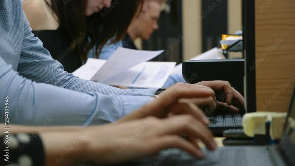 Many hands are typing on a laptop Many hands are typing on a laptop