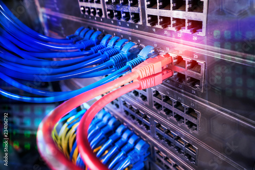 network cables and hub closeup with fiber optical background