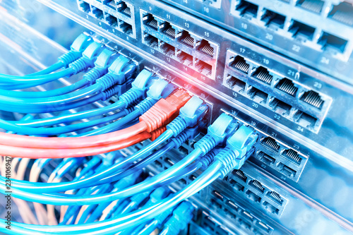 network cables and hub closeup with fiber optical background