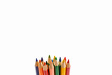 Colored pencils arranged in a group isolated on white background