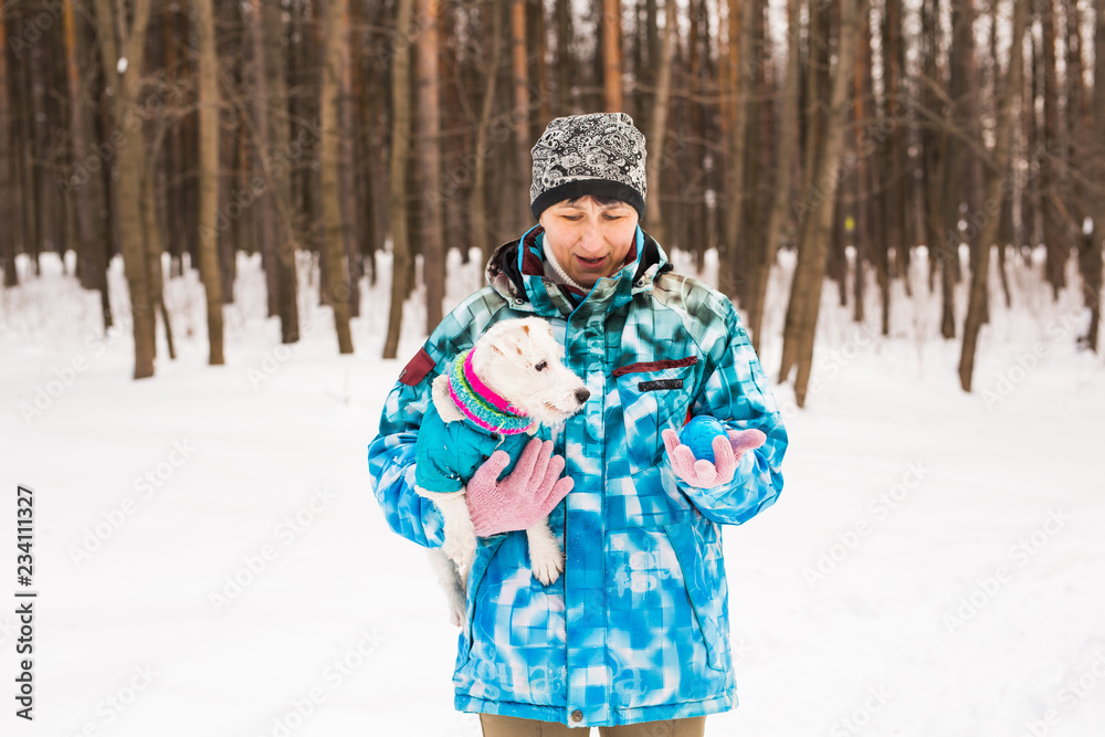 Middle aged woman outdoors with cute dog - Jack Russell Terrier in winter season