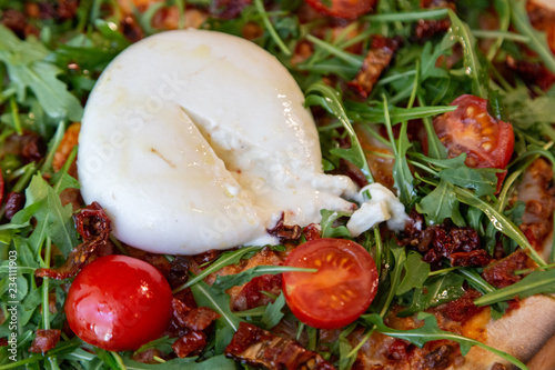 close up of a cut out creamy cheese on a pizza