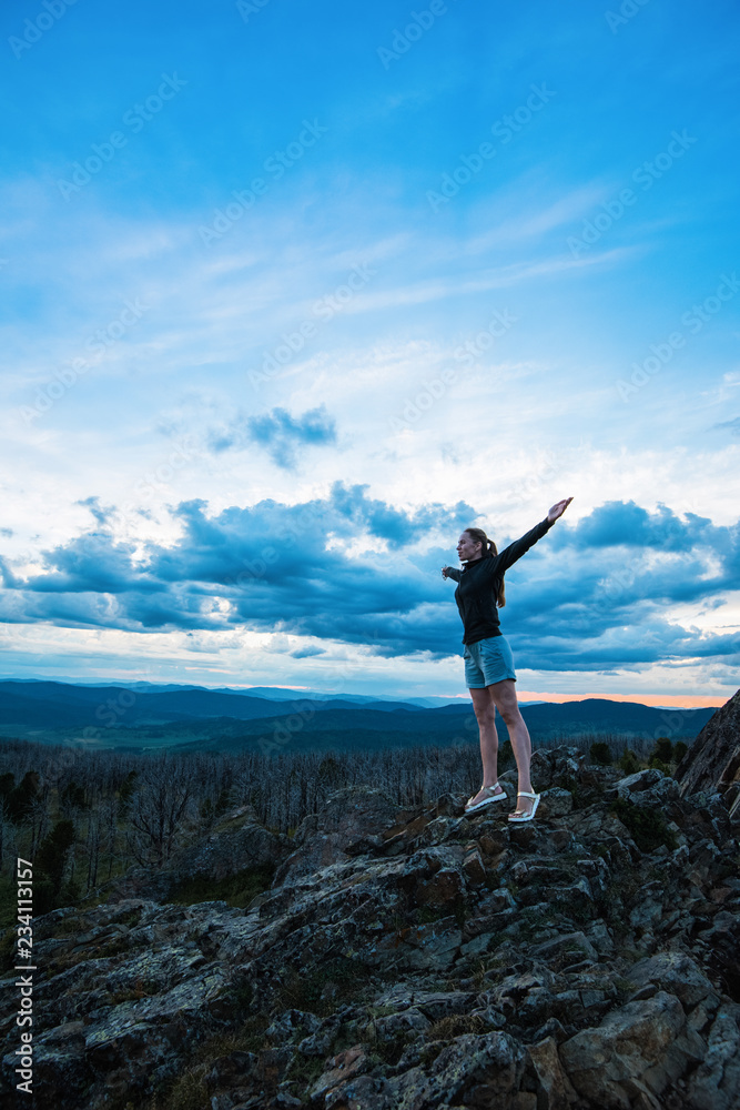 Travel, lesure and freedom concept - woman on the top of Altai mountain, beauty summer evening landcape