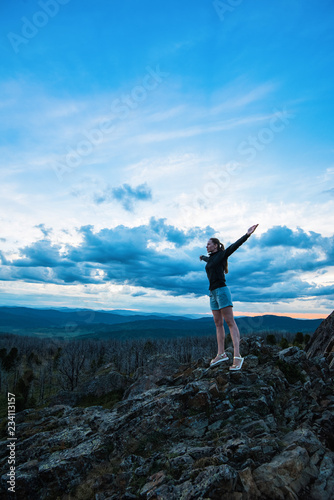 Travel, lesure and freedom concept - woman on the top of Altai mountain, beauty summer evening landcape © olinchuk