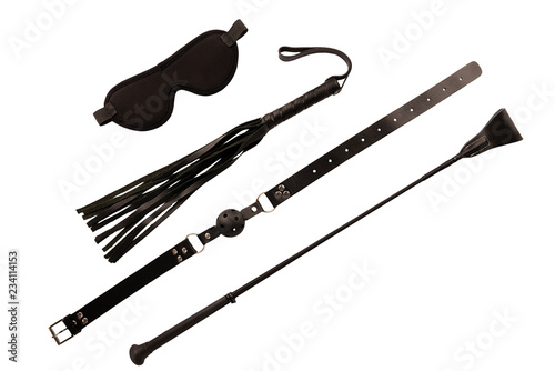 Blindfold mask, riding crop and ball gag, isolated on white background.