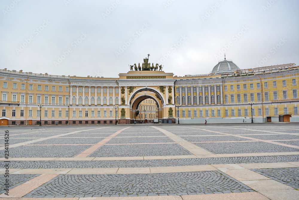 Landmark of St. Petersburg, Russia - Deserted Palace square, façade of general staff and triumphal arch with roman chariot in front of Hermitage by early morning without people. Panoramic front view