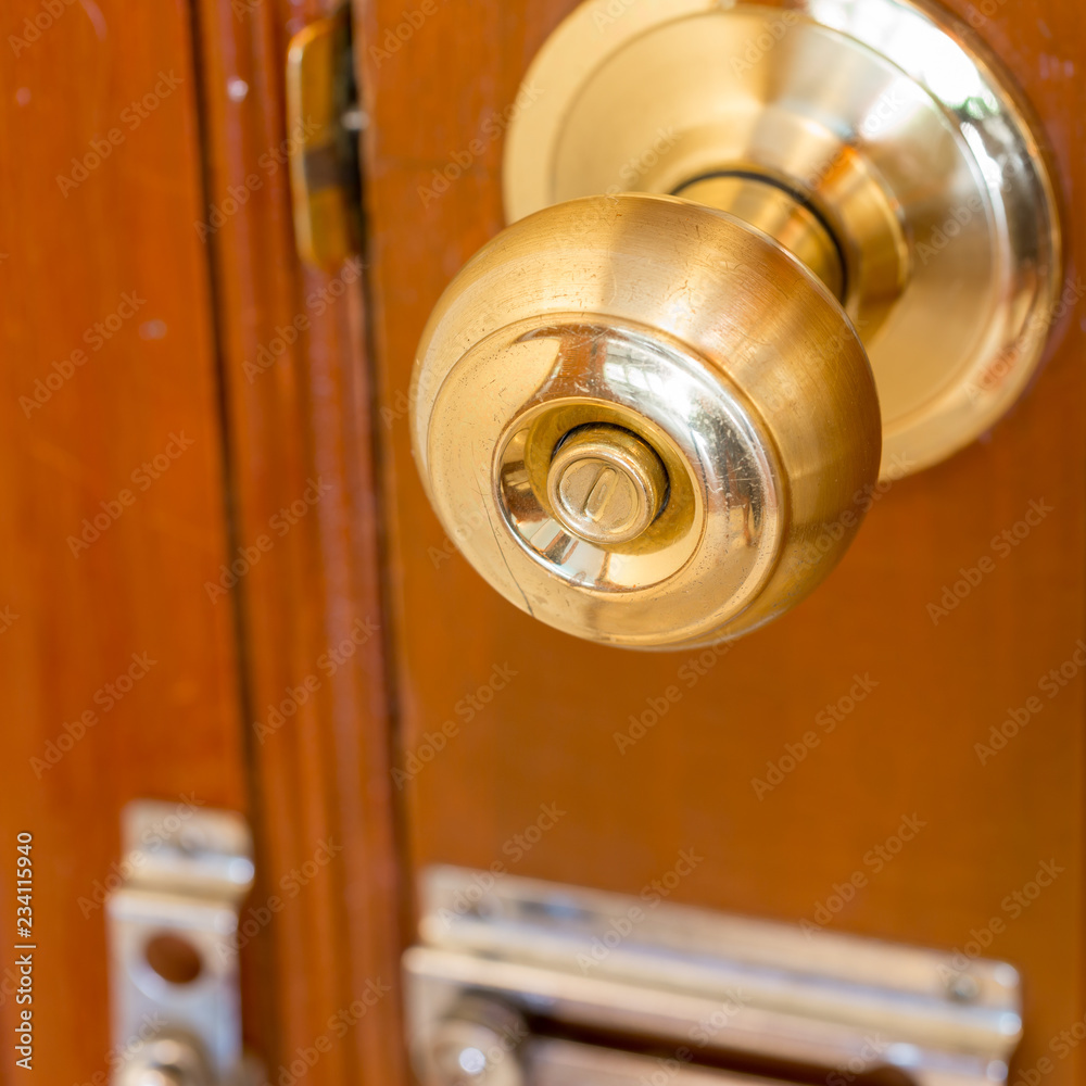 close up of metal handle on a old wooden door,golden door knob. close up of metal handle on a old wooden door,golden door knob.