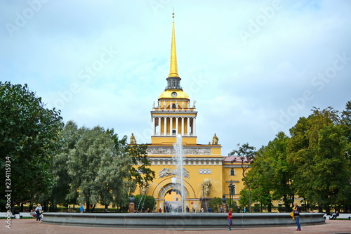 Landmark of St. Petersburg, Russia – yellow façade of admiralty house with arch, tower and  gold spire and fountain. Front view photo